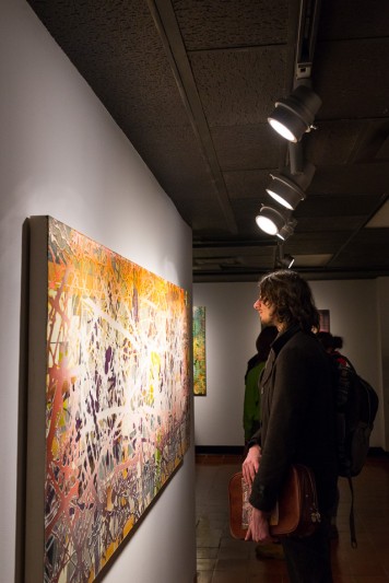 Person viewing Robert Straight's paintings in the Old College Gallery at the University of Delaware