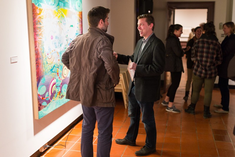 People viewing Robert Straight's paintings in the Old College Gallery at the University of Delaware
