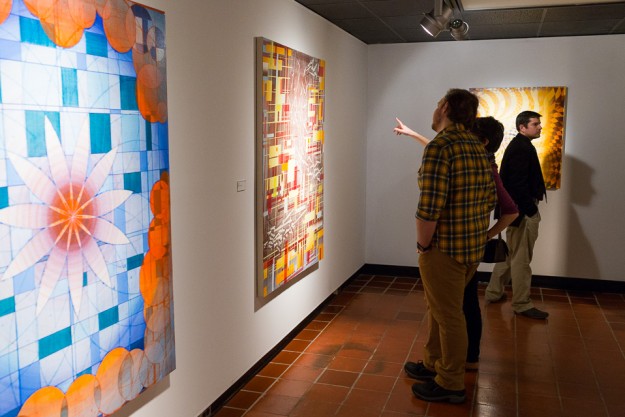 People viewing Robert Straight's paintings in the Old College Gallery at the University of Delaware