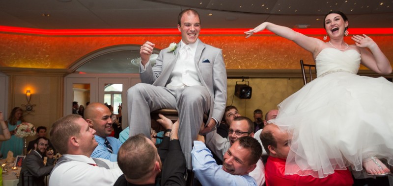 0584-Wedding-Reception-Chesapeake-Inn-blog Bride and Groom up on chairs during the Hava Nagila dance at the Chesapeake Inn