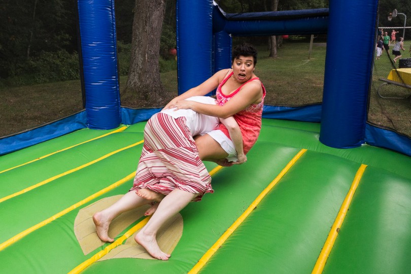 Bride Tackeling Bride Bouncy House at a Wedding